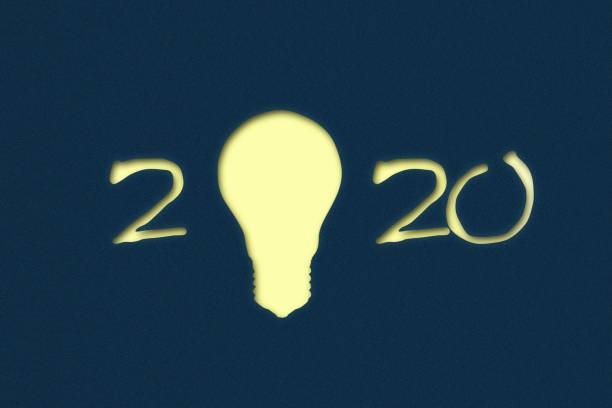 istock 2020. New Year background with numbers and a light bulb on a dark blue background. New Year Ideas Concept. Business. Creation. I 1190432159