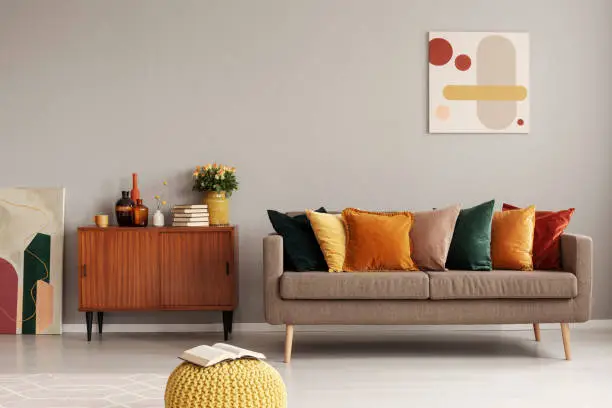 Photo of Retro style in beautiful living room interior with grey empty wall