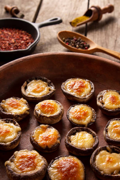 istock Roasted mushrooms with vegetables and parsley under melting cheese 1190433342