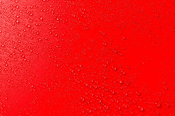 istock Colorful festive red background with water drops 1190433698