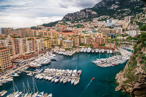 Principality of Monaco. Beautiful panoramic view on Monaco, Monte-Carlo golden hour scenery. View on apartment building, casino, great port with luxury yachts. Monaco is popular travel destination.