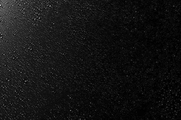 istock Drops of water on a black surface. Condensation, Top View. 1190433808
