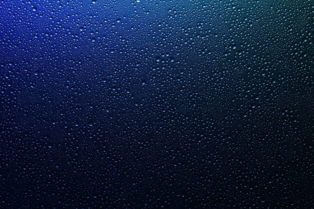 istock Water droplets on a translucent rainbow glass background with gradient 1190433858