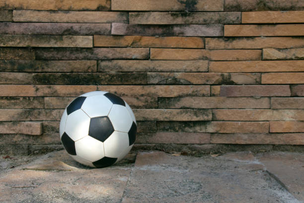 istock a ball on floor with crack brick background,dirty wall. 1190435535