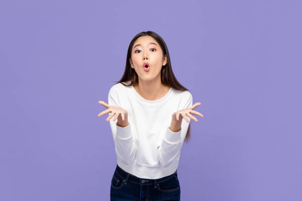 Wow surprised young Asian girl with both hands open