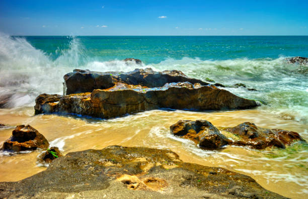 Beautiful landscape with rocks and sea waves on a sunny beach