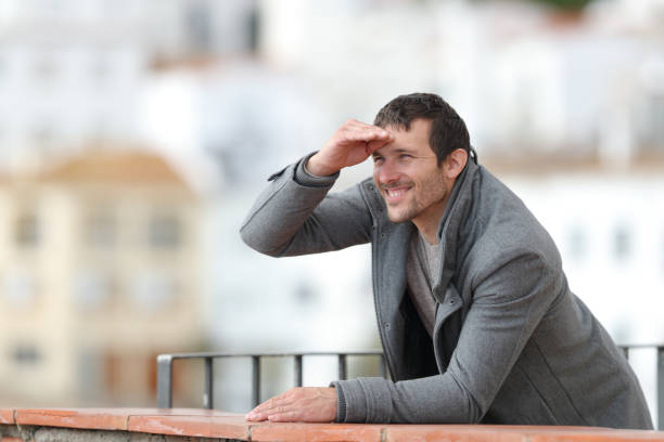 istock Happy man contemplating with hand on forehead 1190438054