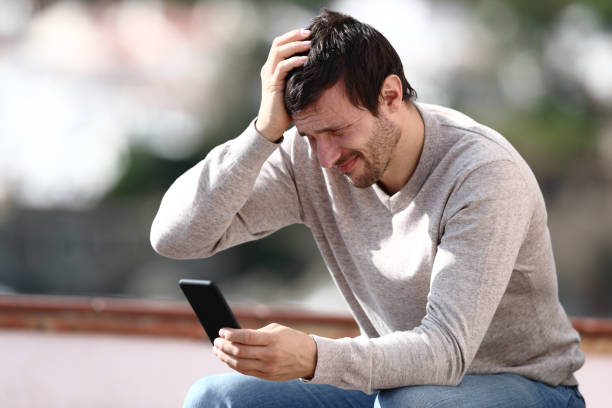 istock Worried man checking phone after mistake outdoors 1190438202