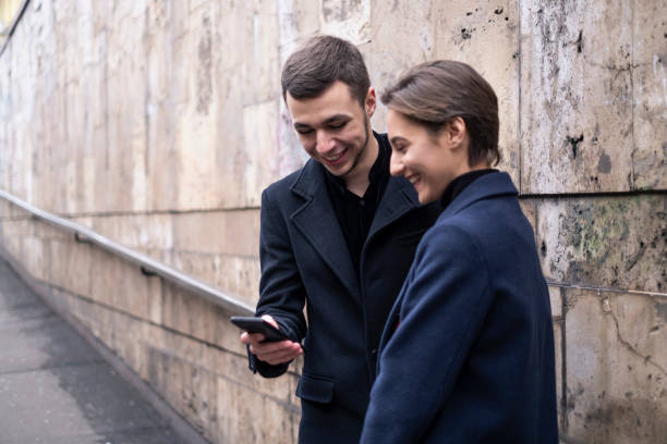 istock Young Couple Looking to Their Mobile Phone 1190439112