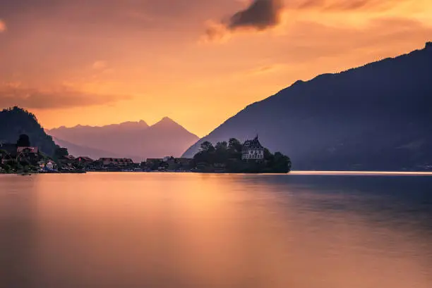Sunset above Iseltwald peninsula and forme castle in Switzerland, now Rehabilitation Center of Seeburg. Long exposure.
