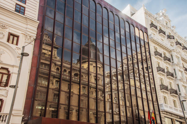 istock Old building reflected on a glass office building facade 1190439535