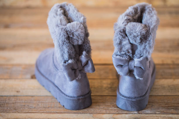 istock Winter boots at wood background 1190439555