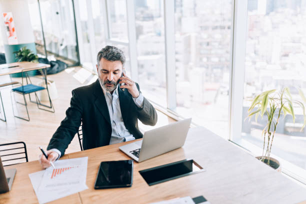 istock Businessman at the office talking on cell phone 1190440253