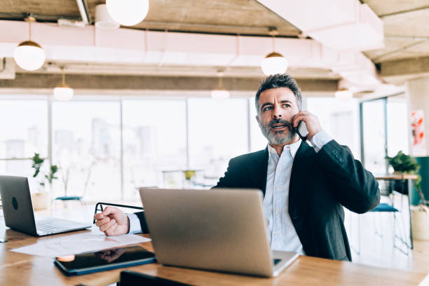 istock Businessman at the office talking on cell phone 1190440274