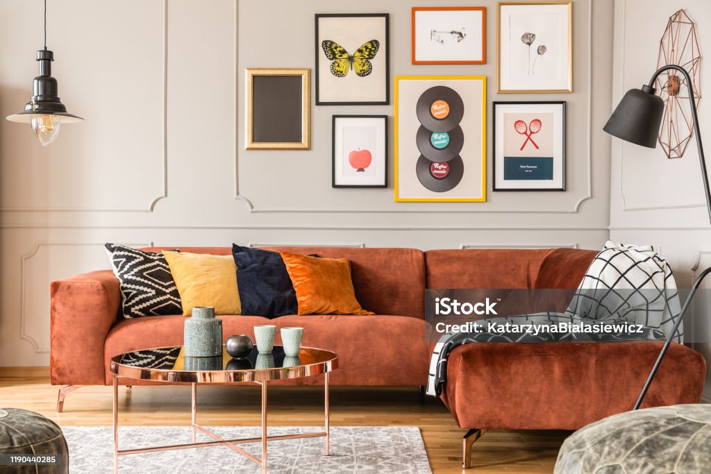 Eclectic living room interior with comfortable velvet corner sofa with pillows Wall - Building Feature Stock Photo