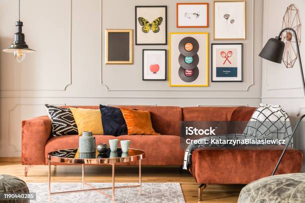 Eclectic Living Room Interior With Comfortable Velvet Corner Sofa With Pillows Stock Photo - Download Image Now
