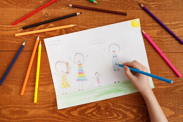 istock Character Child Drawing Image on Wooden Table 1190440321