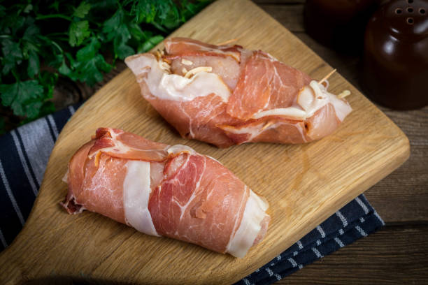 istock Raw chicken breast stuffed with champignon wrapped with bacon. 1190442054