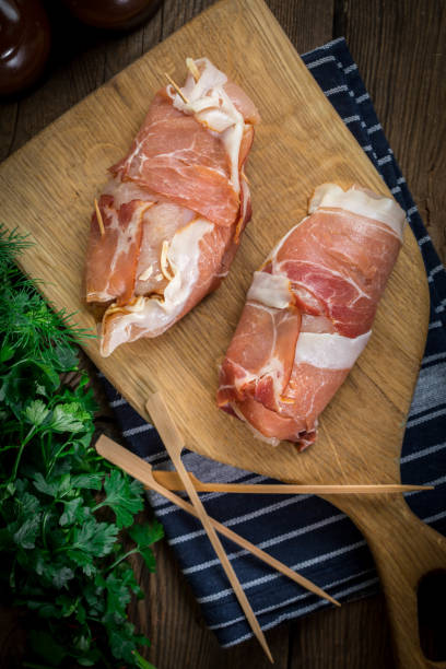 istock Raw chicken breast stuffed with champignon wrapped with bacon. 1190442063