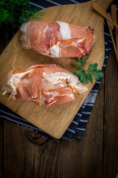 istock Raw chicken breast stuffed with champignon wrapped with bacon. 1190442097