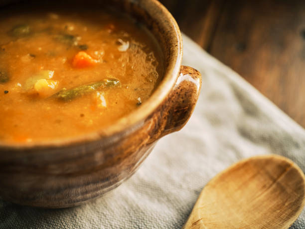 istock Rustic bow of Vegetable Soup on kitchen linen on an aged wooden table top. 1190442190
