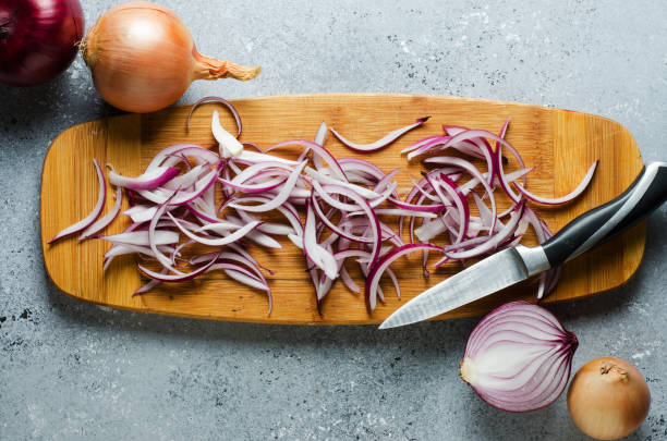 istock Sliced red onion on wooden chopping Board. Top view 1190442356