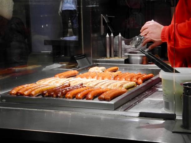 istock Man cooking sausages on grill 1190442378