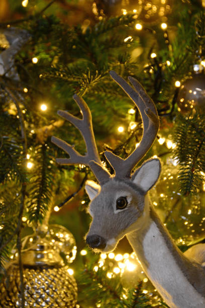 istock Stuffed deer toy in a Christmas tree. 1190444047