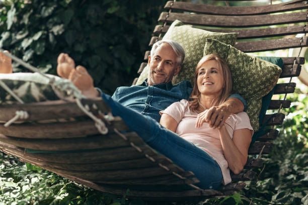istock Smiling mature couple lying together in a hammock outside 1190445027