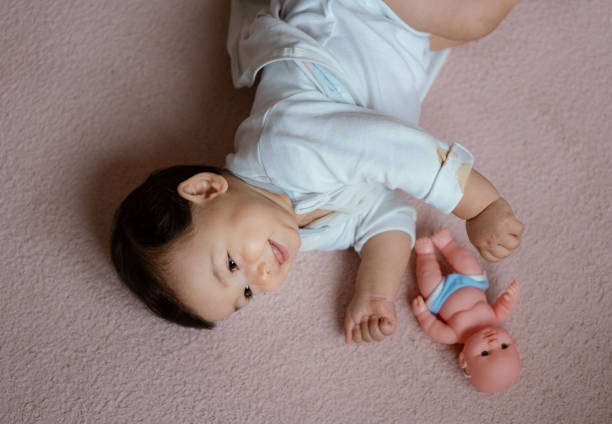 istock Cute baby boy lying on carpet 1190448095