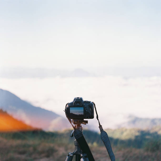 istock Person Taking a Photo in digital camera by film camera. 1190448957