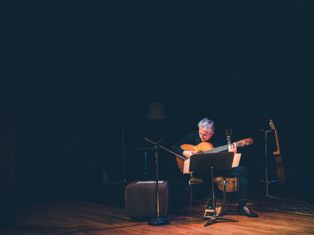 istock Male guitarist performing on the stage 1190449354