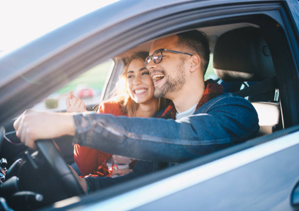 Couple driving in car stock photo