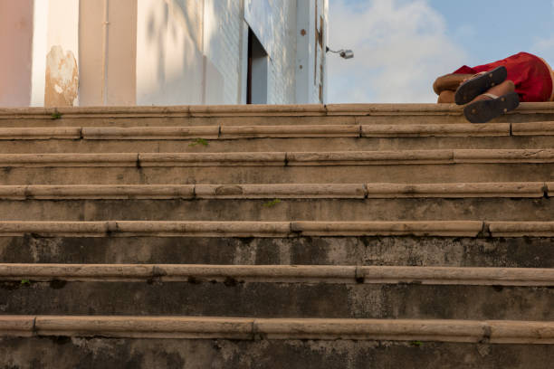 Sao Luis do Maranhao, Maranhao, Brazil - May 18, 2016: Homeless man sleeping in the staircase of the Church of Sao Joao, in the historic center of Sao Luis do Maranhao