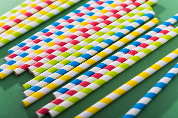 istock Bright colored cocktail straw on a color green background 1190451475