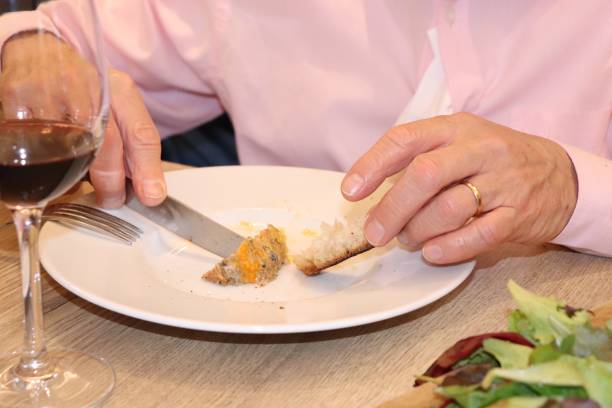 istock Man spreading foie gras on his bread 1190451538