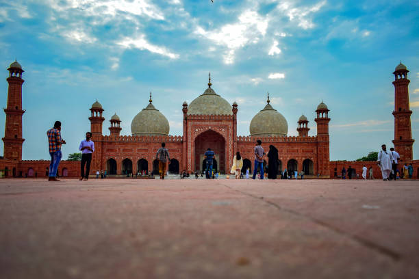 The Badshahi Mosque,Lahore Pakistan The Badshahi Mosque (Urdu: بادشاھی مسجد), or the 'Emperor's Mosque', was built in 1673 by the Mughal Emperor Aurangzeb in Lahore, Pakistan. It is one of the city's best known landmarks, and a major tourist attraction epitomising the beauty and grandeur of the Mughal era.

 

Capable of accommodating over 55,000 worshipers, it is the second largest mosque in Pakistan, after the Faisal Mosque in Islamabad. The architecture and design of the Badshahi Masjid is closely related to the Jama Masjid in Delhi, India, which was built in 1648 by Aurangzeb's father and predecessor, emperor Shah Jahan. lahore pakistan photos stock pictures, royalty-free photos & images