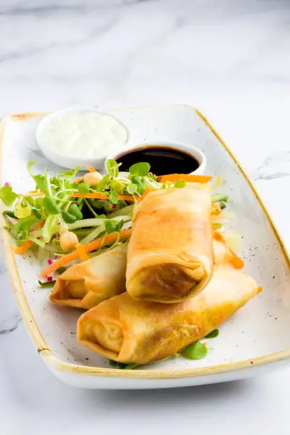 Three spring rolls, with salad and soy sauce