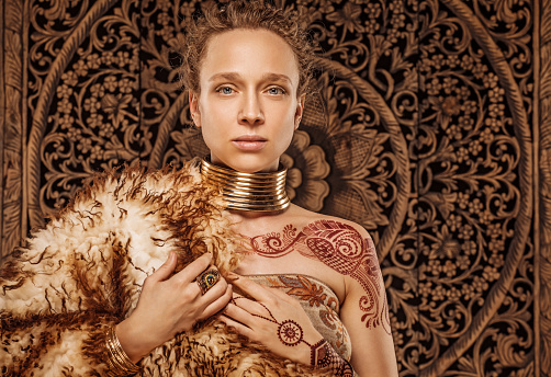 Beautiful blonde Ethnic Warrior Woman wearing mehndi pattern henna tattoo