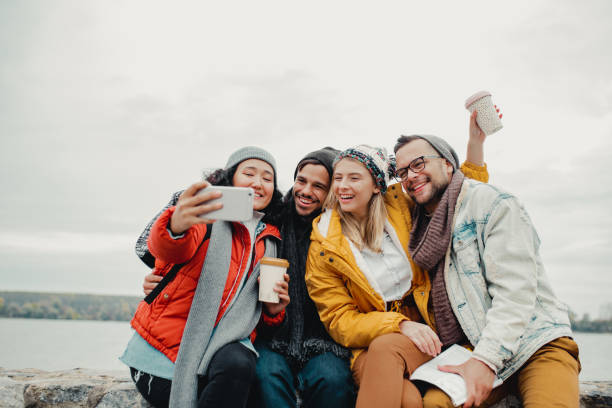 istock Group of friends taking a selfie by the river 1190457500