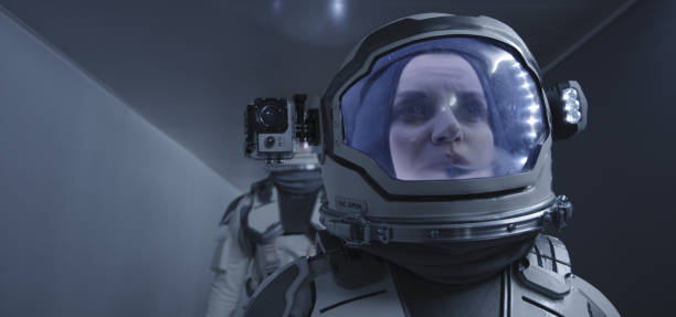 istock Female astronaut walking down a corridor 1190458707