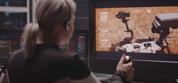 Photo of Woman controlling Mars rover with remote controller