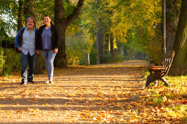 istock Couple walking in a public park during Autumn 1190459873