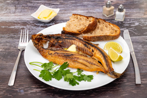 Kipper breakfast Kipper breakfast with crusty bread and butter kipper stock pictures, royalty-free photos & images