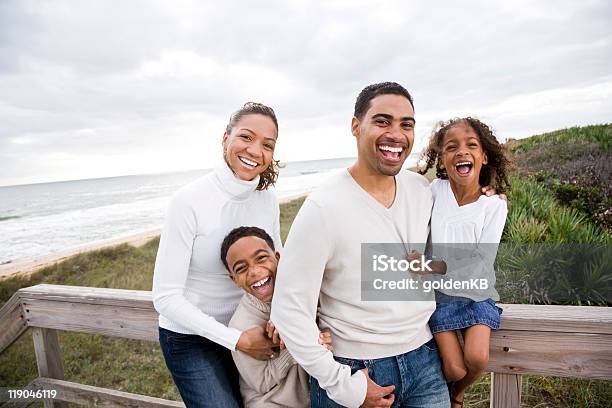 Happy Africanamerican Family Of Four On Beach Stock Photo - Download Image Now - Happiness, Family, African-American Ethnicity