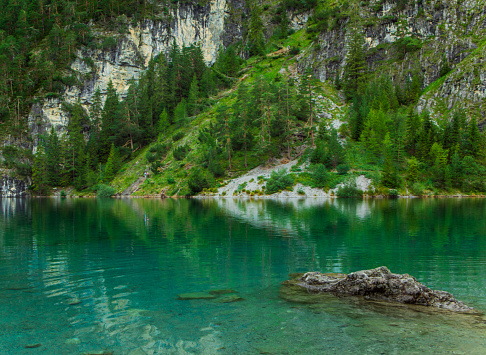 Cool clear turquoise pool with small fish in Plitvice Lakes National Park in Croatia.