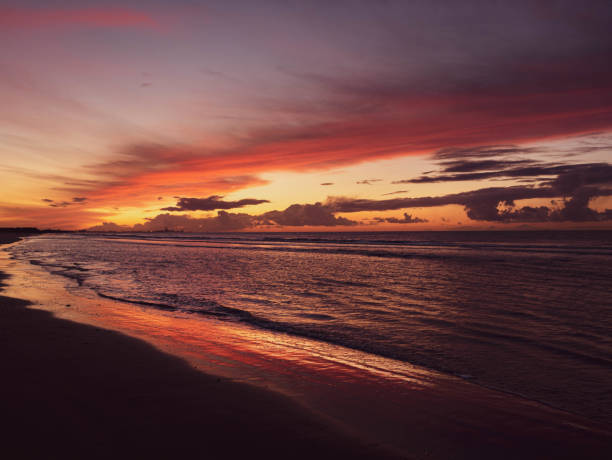 istock Sun setting behind industrial complex in the distance creating colorful sky 1190462110