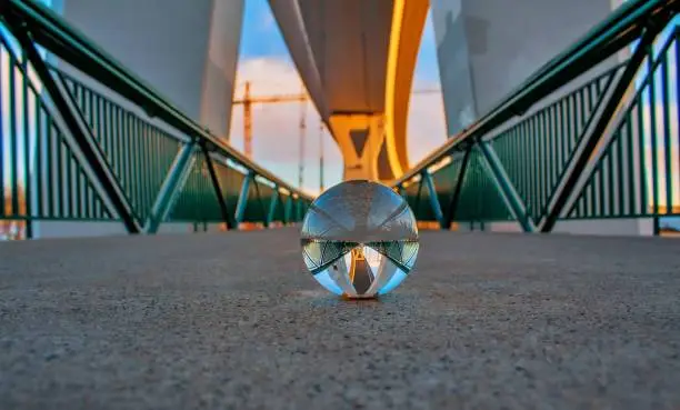 A unique view of a bridge walkway through a crystal ball.