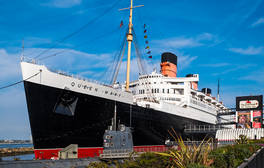 The Queen Mary ocean liner, now a museum and major tourist attraction docked in Long Beach, California, with the Russian submarine  'Scorpion' in front.