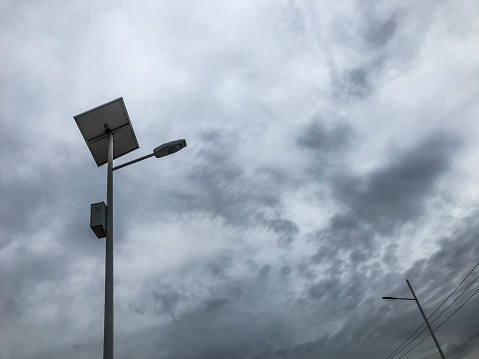 Cloudy sky behind of electric street lamp at stormy and cloudy day
